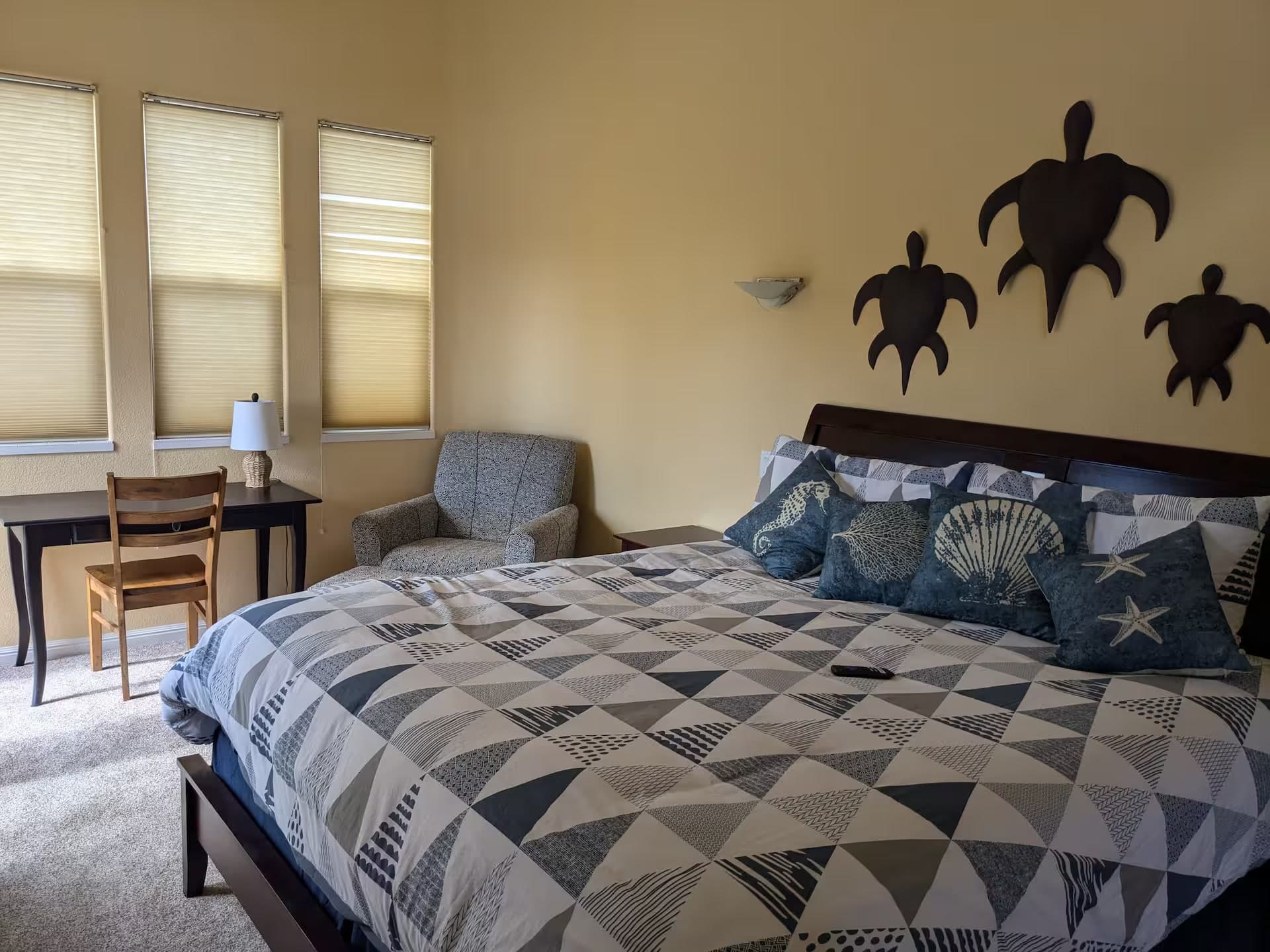 Primary bedroom with ocean light and a workspace nearby